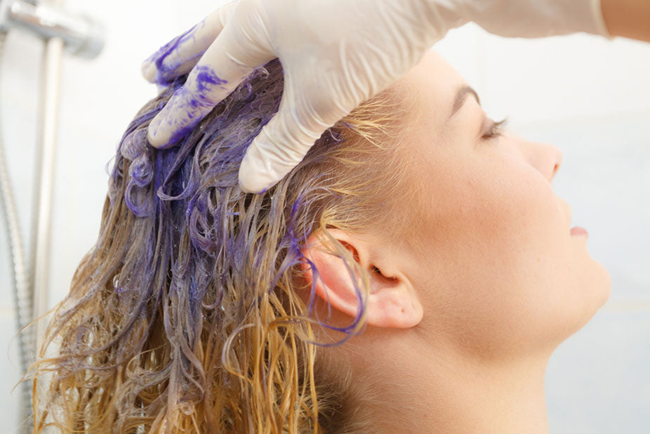 woman applying colored shampoo
