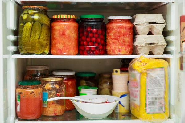 A variety of canned goods in the refrigerator