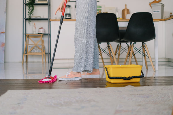 a woman cleaning the floor