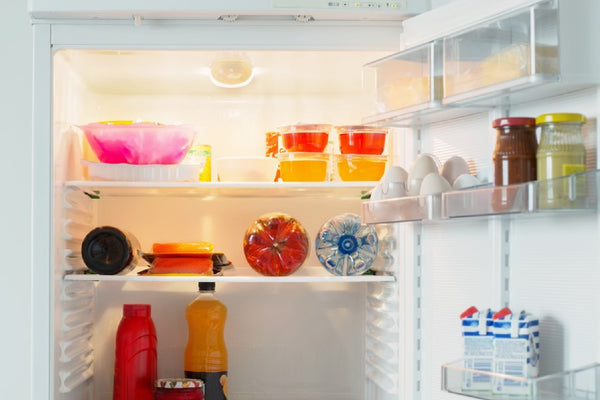 an opened refrigerator with some foods inside it