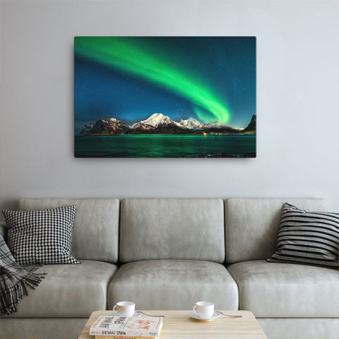 canvas print of the aurora northern lights above a sofa in a living room