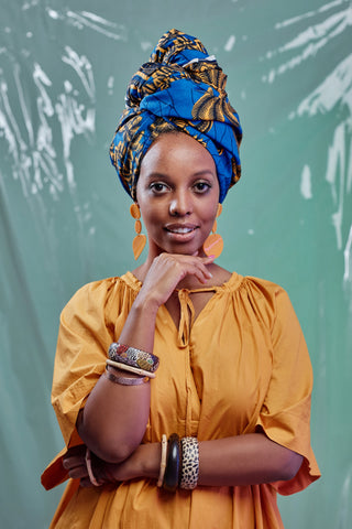 Woman wearing a plain top and an African print headwrap