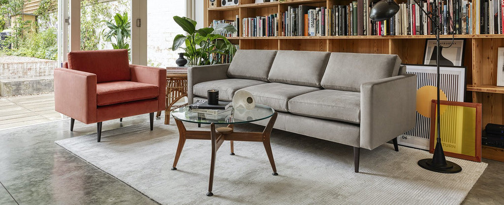 Orange velvet armchair and grey sofa - Swyft