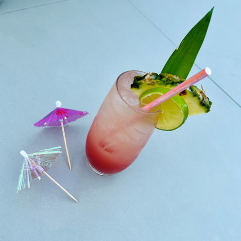 "Hi Barbie" -rum punch cocktail with fruit, pink straw and umbrella garnish in celebration of the Oscars