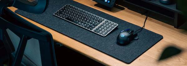 Tracer Gaming Mouse On A Material Mouse Mat Next To A Mechanical Keyboard