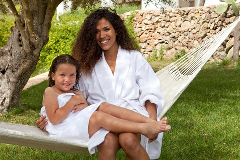 Child and women in luxury robes and towels on a hammock