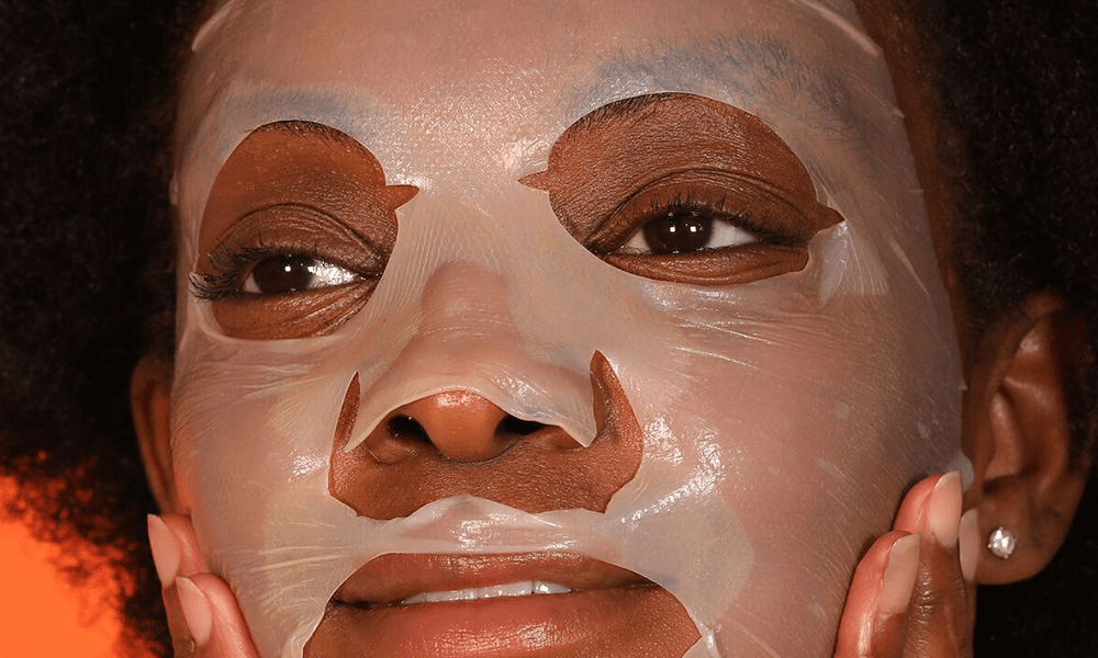 Woman applying Vitamin C Lactic Biocellulose mask