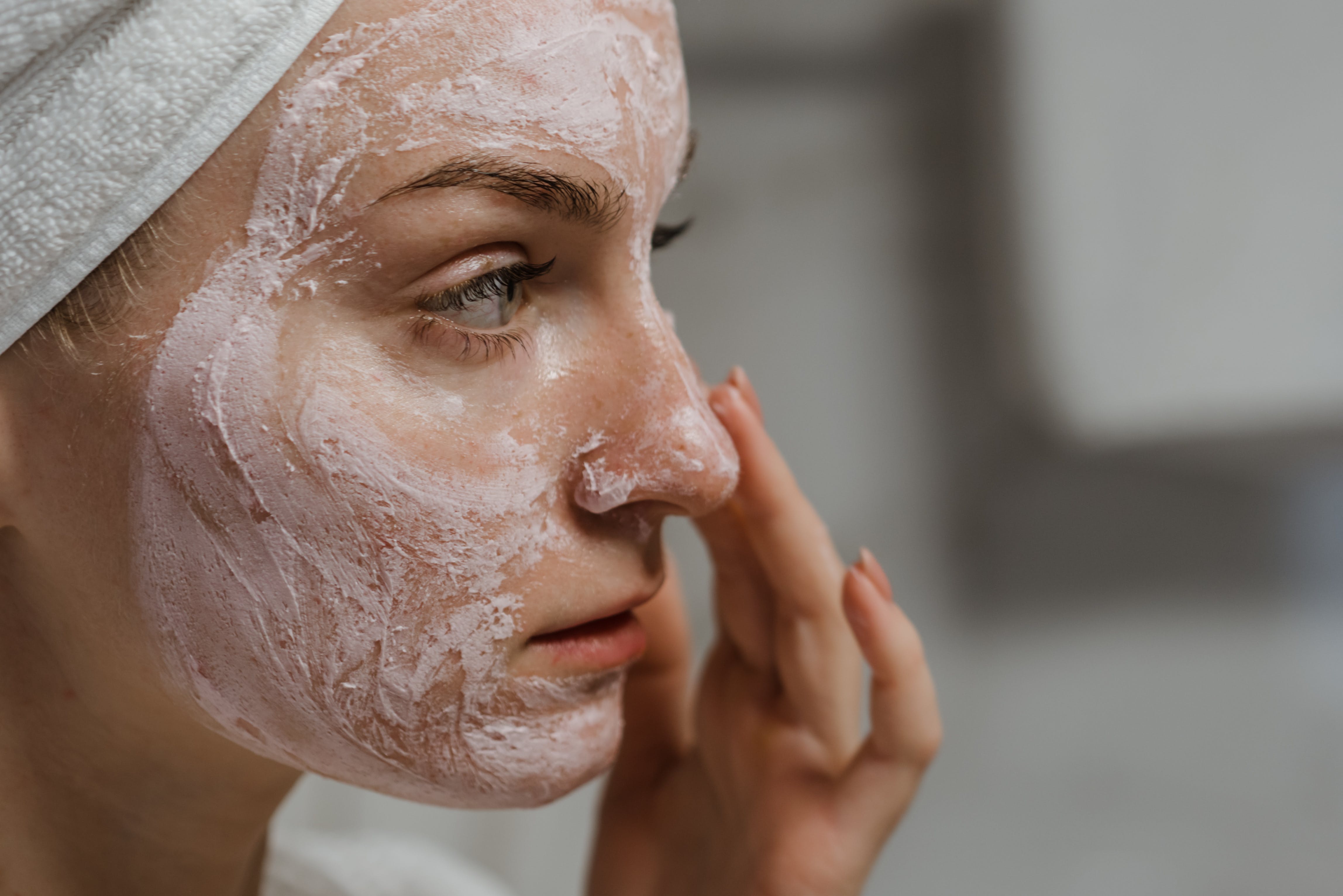 Woman putting on face mask