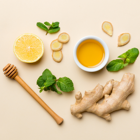 Stock photo of natural wellness products with manuka honey, lemon, essential oil, clay, balm, rosemary herbs, and natural soap