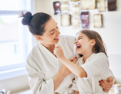 mum and daughter brushing teeth