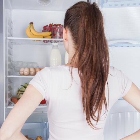 woman staring at fridge