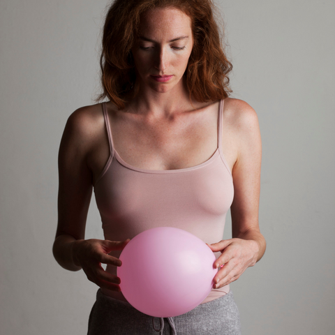 woman holding balloon bloating