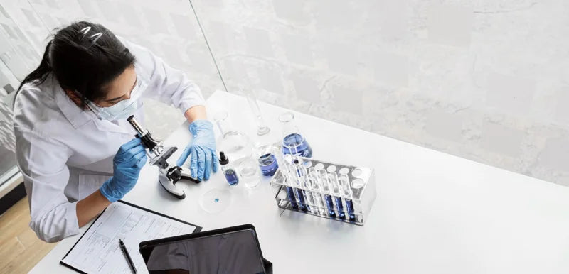 Scientist analyzing genetic samples to estimate the full genetic testing cost.