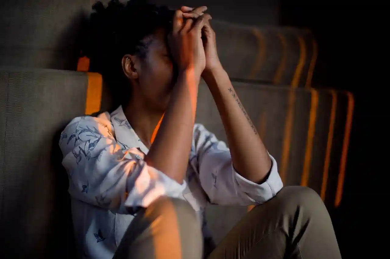 Woman experiencing stress and fatigue, a common effect of oxidative stress on the body
