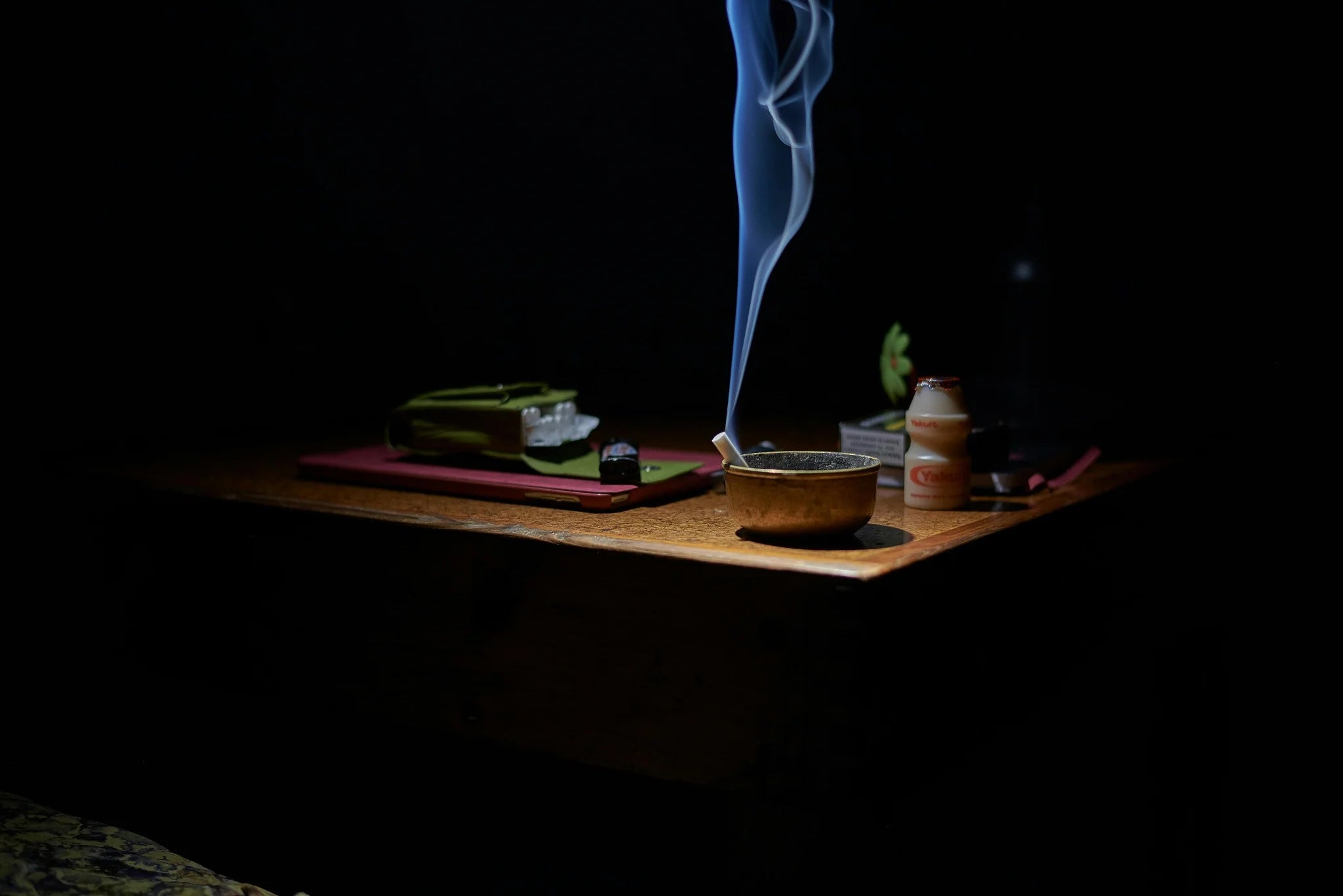 a cigarette left in the ashtray to indicate quitting smoking