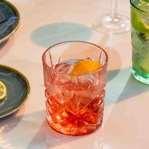 Negroni cocktail on a rocks glass with an orange peel garnish