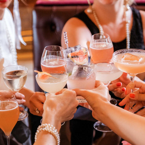 Women clinking various cocktails