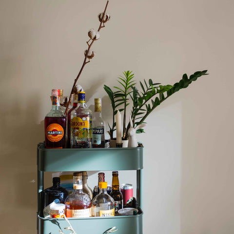 Home bar cart with bottles of liquor 