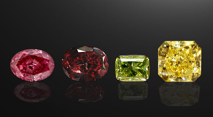 Image of four fancy color diamonds: Fancy Pink, Fancy Red, Fancy Green, and Fancy Yellow