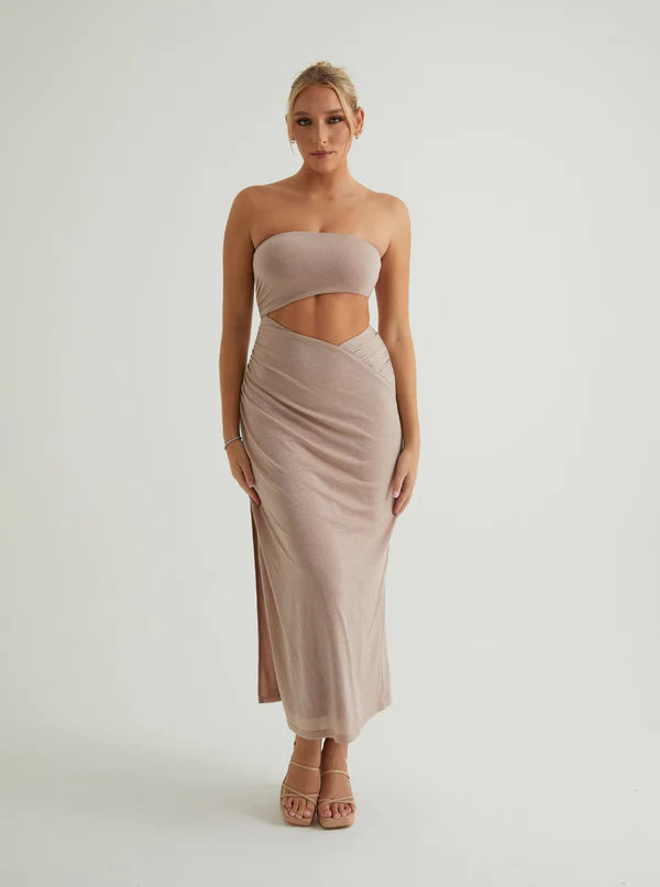 Woman in a beige tube maxi dress with a waist cutout
