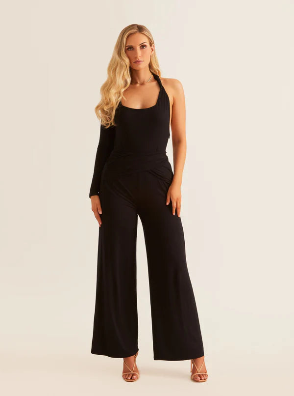 Woman in a black one-sleeve jumpsuit