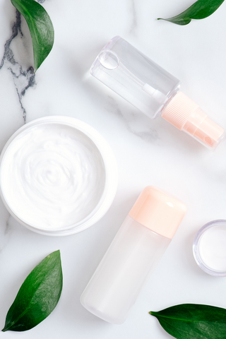 Organic beauty creams and products with marble and leaf background