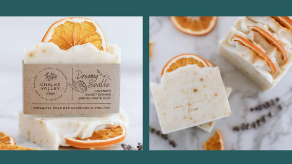 Dreamy Seville soap with white British clay, lavender, and sweet orange. There is a dried orange top piece and orange zest in the soap.