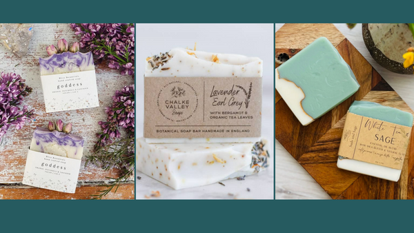Banner image of three different kinds of luxury handmade soaps. One has dried rose buds with purple swirls. The middle is lavender earl grey. The right is white tea sage with a gold mica line through it.
