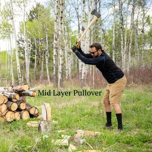 man chopping wood wearing black and blue alpaca wool mid layer pullover