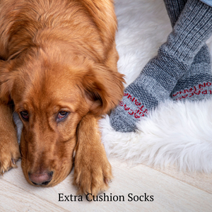 dog laying down next to someone's feet wearing alpaca wool extra cushion socks