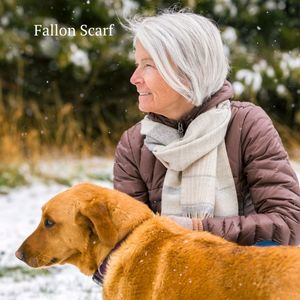 woman kneeling outside next to dog wearing warm alpaca wool fallon scarf