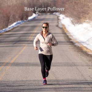 woman running down road wearing oatmeal and purple alpaca wool base layer