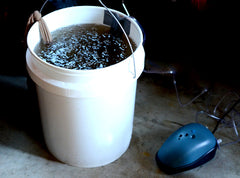 composting aerating in a white bucket with air bubbler pump