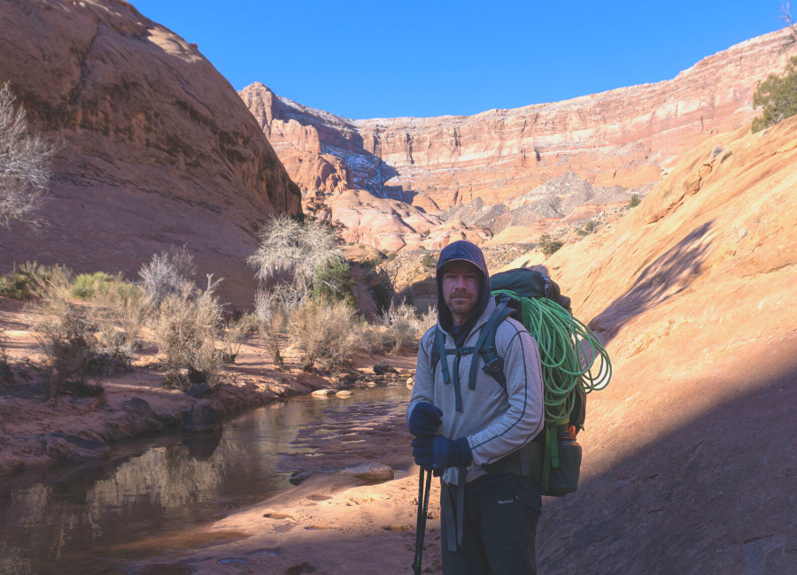 man standing in canyonlands wearing oatmeal and black alpaca wool base layer pullover