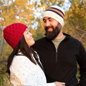 man and woman smiling at each other wearing alpaca wool backcountry beanie hat