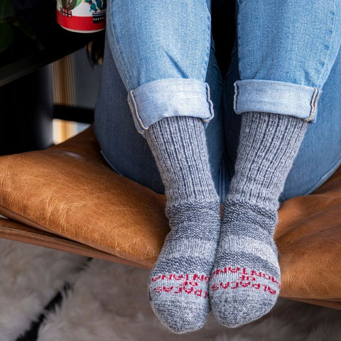 person's feet wearing warm alpaca wool extra cushion socks for cold feet