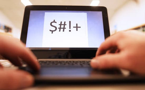 Person typing "$#1+" on computer