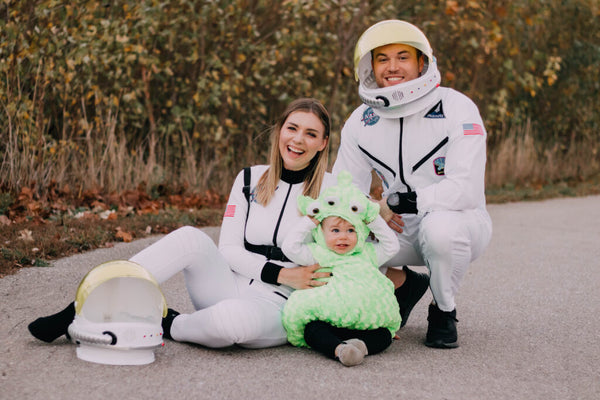 A family dressed in Astronaut and Alien Halloween costumes.