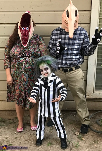 A family of three dressed in a Beetlejuice group Halloween costume.