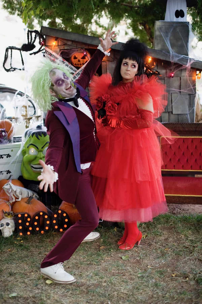 Couples costume featuring a couple dressed as Beetlejuice and Lydia Deetz.