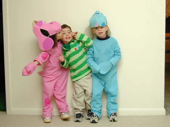 Three children wearing Blue's Clues Halloween costumes.