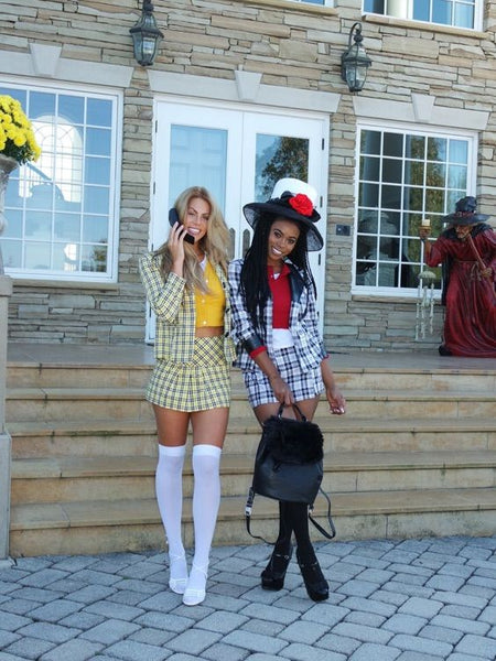 Two women dressed up as Cher and Dionne from Clueless.