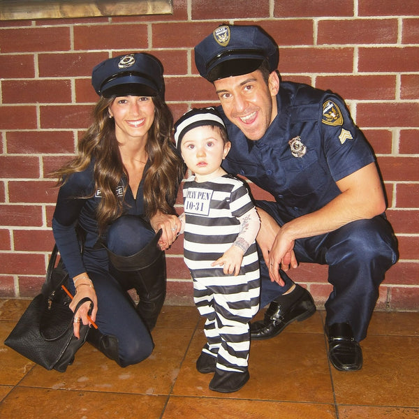 A family dressed in Police Officer and Prisoner Halloween costumes.