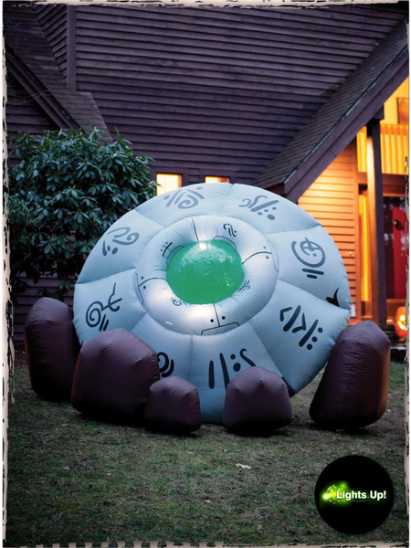 An inflatable Halloween decoration featuring a crashed UFO surrounded by rocks.