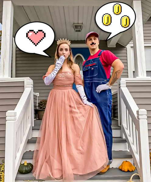 A man and woman dressed as Princess Peach and Mario from the Super Mario Bros. video games.