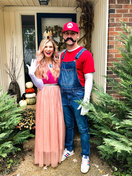 A man and woman wearing DIY Mario and Princess Peach Halloween costumes.