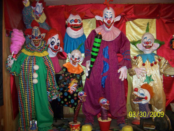 A group of people dressed in Halloween costumes as the characters from Killer Klowns from Outer Space.