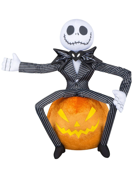 A plush Halloween decoration in the likeness of Jack Skellington from Nightmare Before Christmas sitting on a pumpkin.