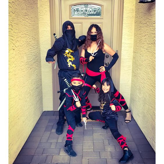 A family dressed in ninja Halloween costumes.
