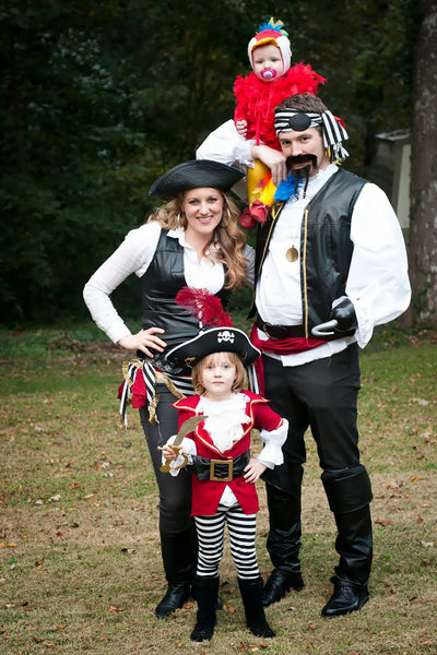 A family of four dressed in a pirate-themed group Halloween costume.